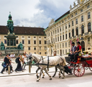 Vienna city center featuring St. Stephen's Cathedral, bustling streets, historic architecture, and vibrant café culture under a sunny sky.