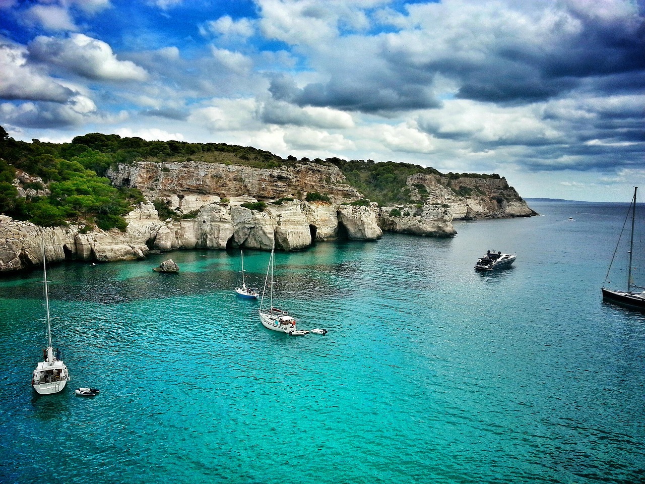 Pristine waters and sandy shores of Cala Macarella, a breathtaking beach in Menorca.